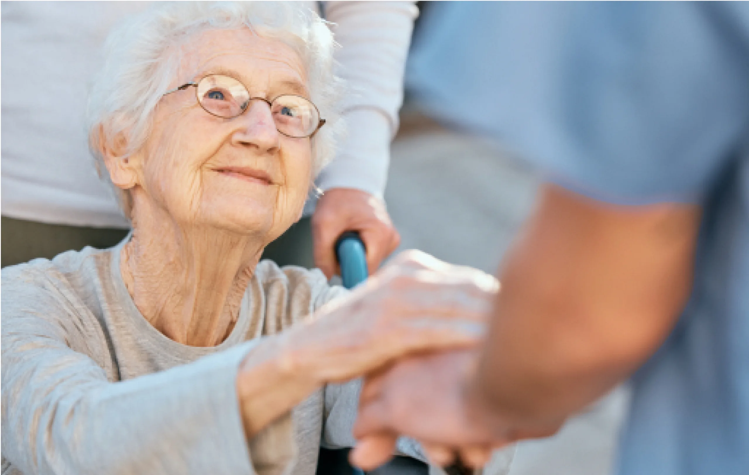 holding-hands-caregiver-and-senior-woman-in-wheel-2022-12-23-00-58-17-utc