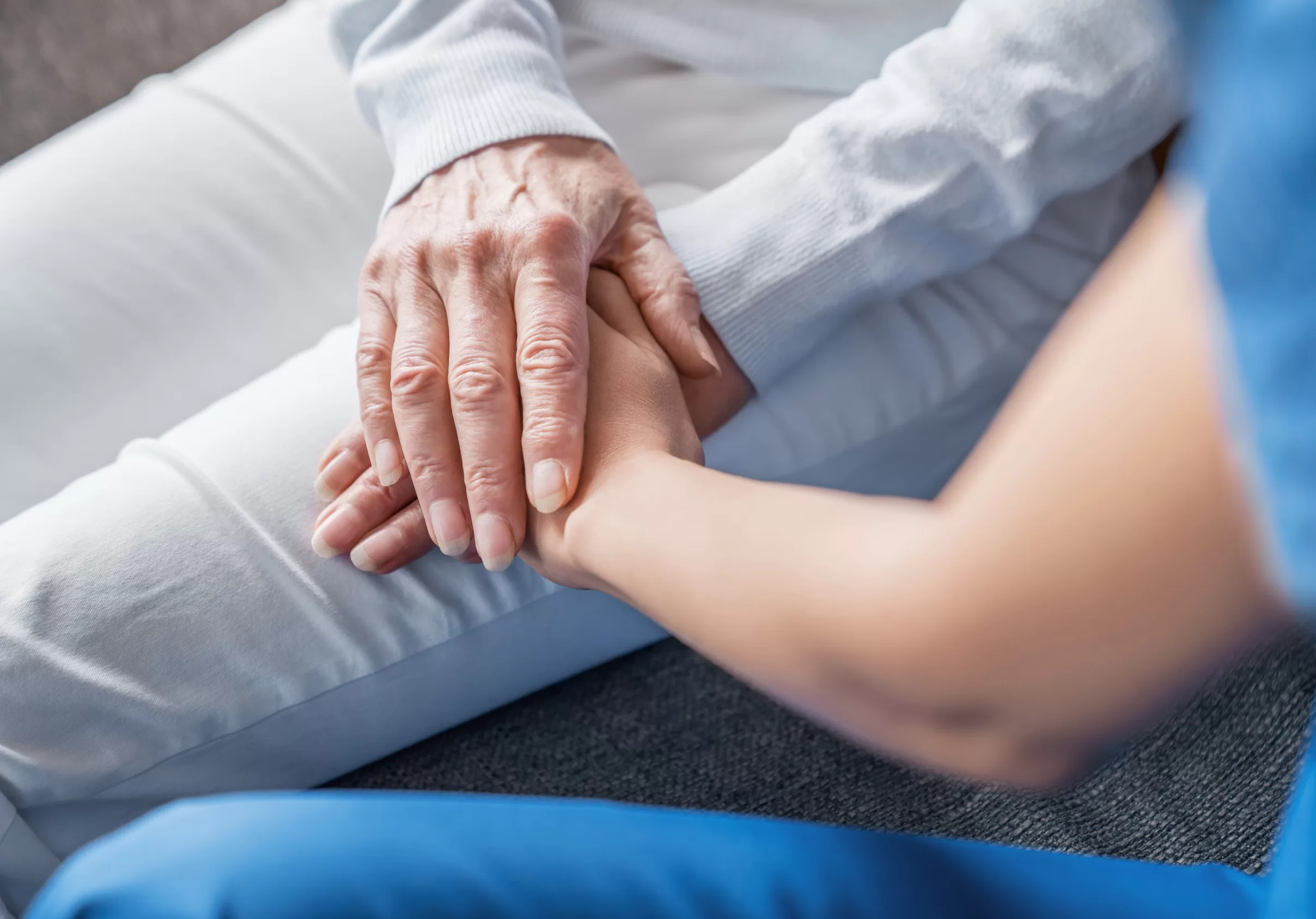 close-up-image-of-caregiver-holding-hands-of-elder-2022-05-31-02-23-30-utc