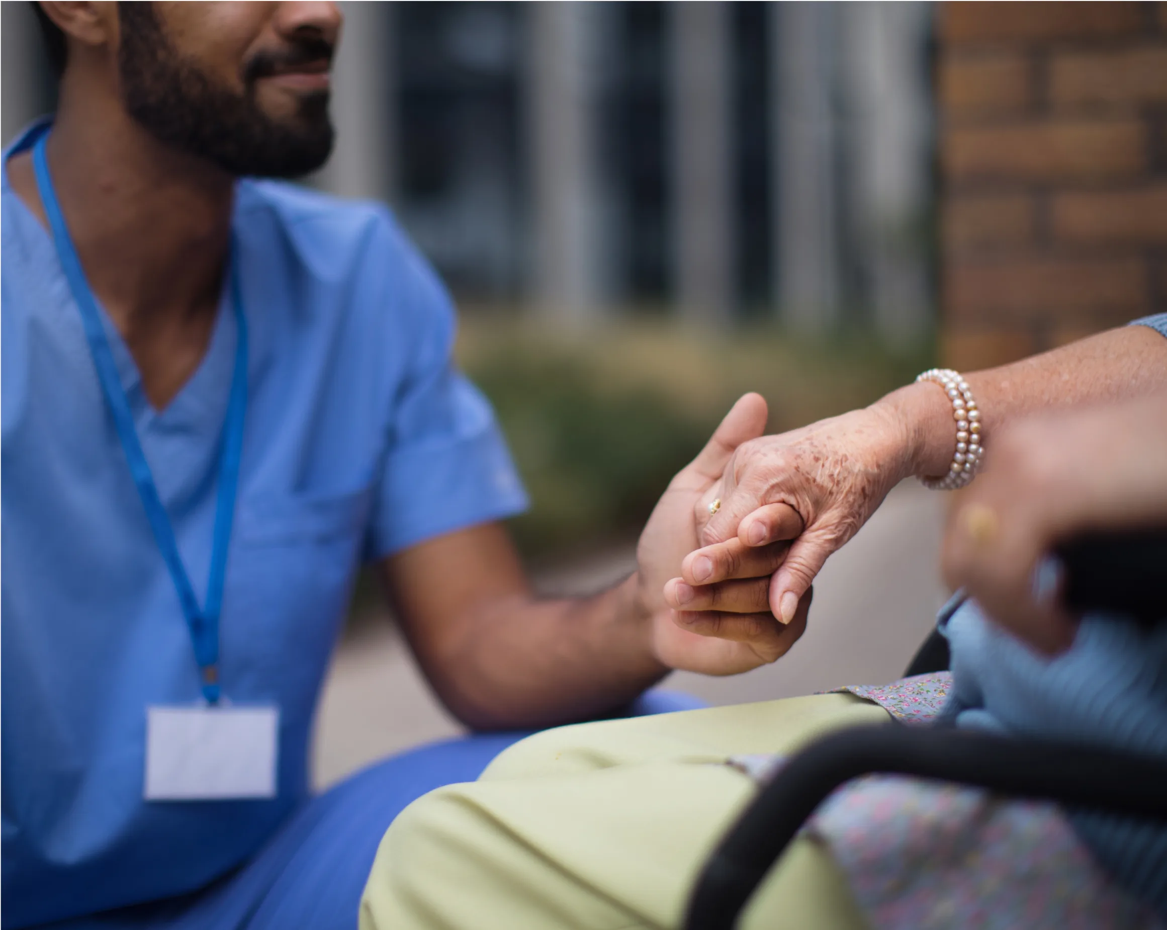 close-up-of-caregiver-holding-hand-of-his-client-o-2022-11-09-05-18-47-utc