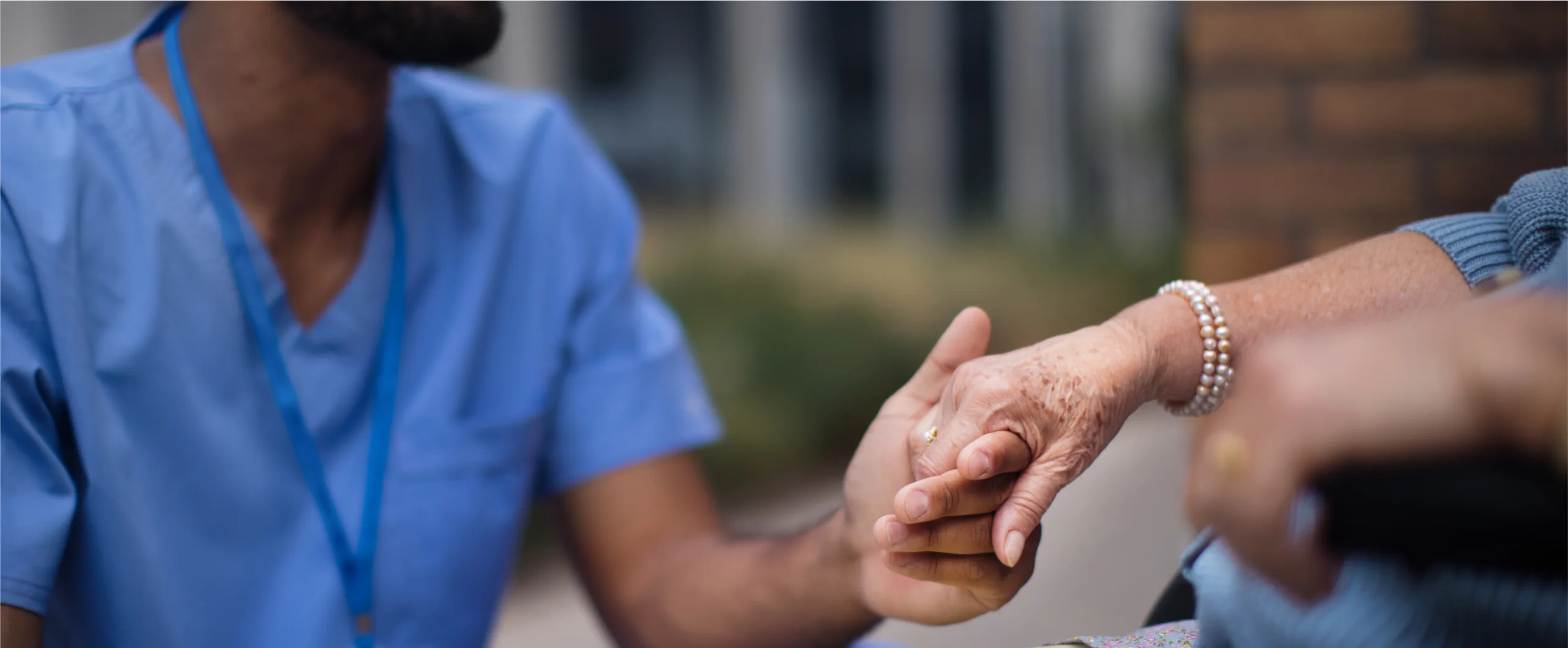 close-up-of-caregiver-holding-hand-of-his-client-o-2022-11-09-05-18-47-utc